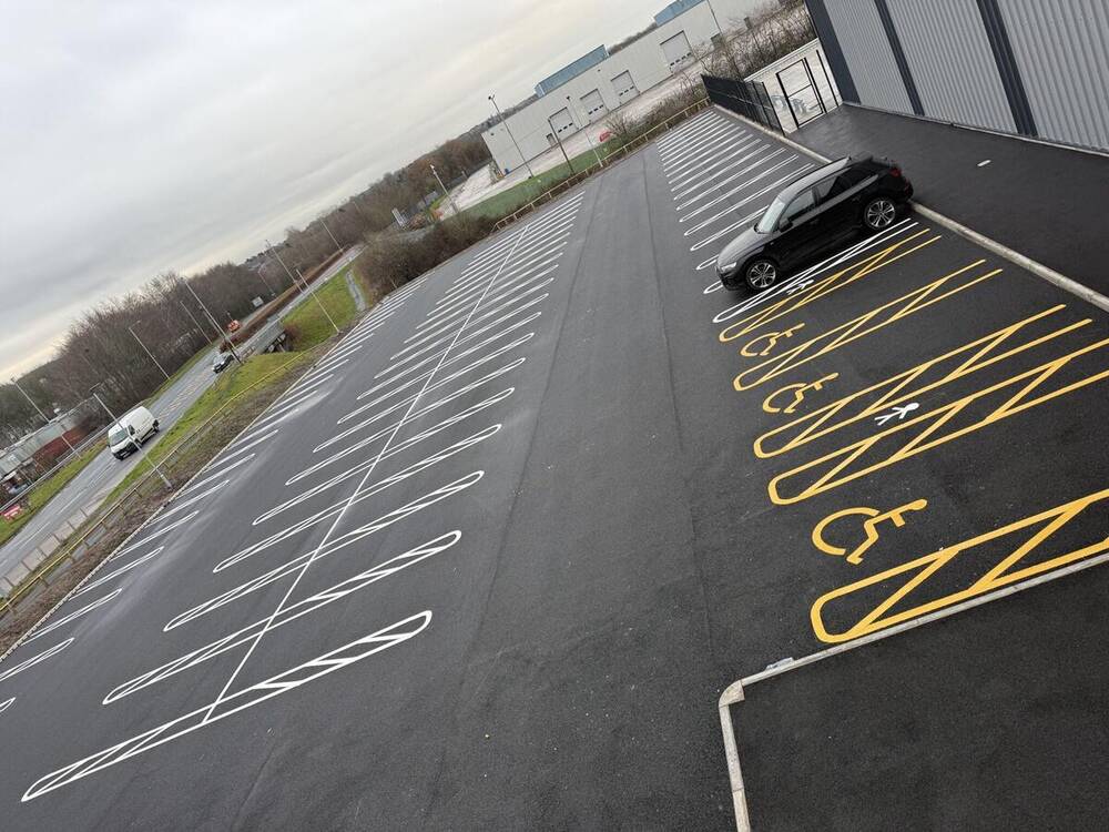 Fresh car park bay markings with yellow accessible bays and wheelchair symbols by C&R